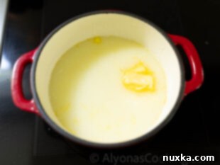 Buttermilk and butter being warmed in a saucepan for English muffins