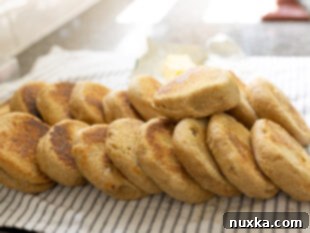 A big batch of homemade English muffins made from fresh milled flour (whole wheat)