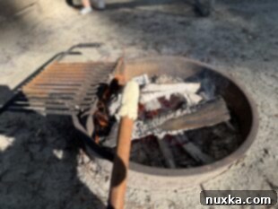 Biscuit dough roasting over an open campfire on a stick, turning golden brown