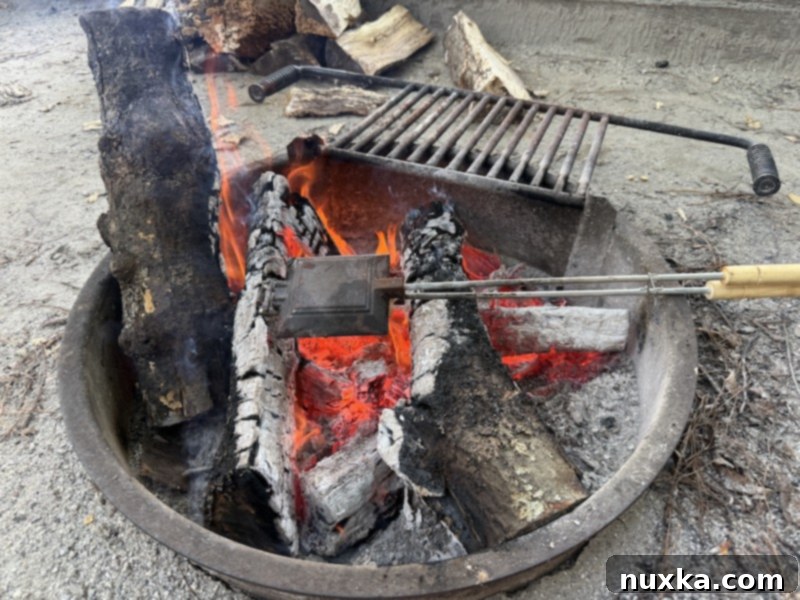 image of mountain pie maker over a fire to season 