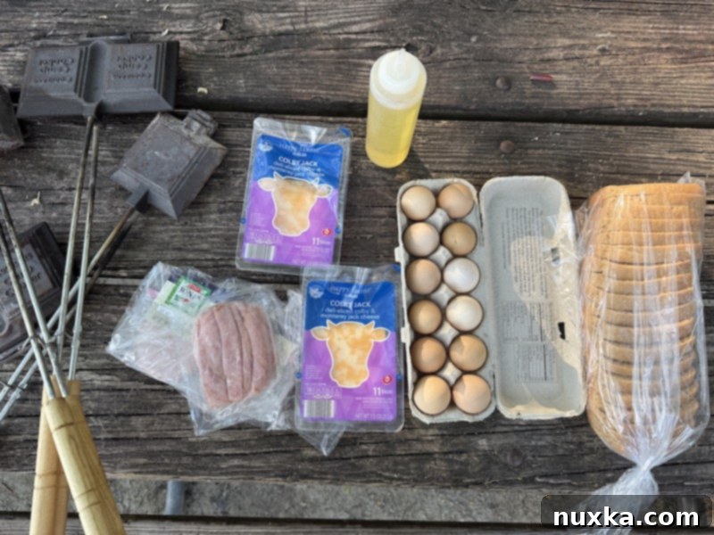 image of all mountain pie ingredients (whole wheat bread, eggs, ham, cheese, cooking oil, mountain pie makers) 