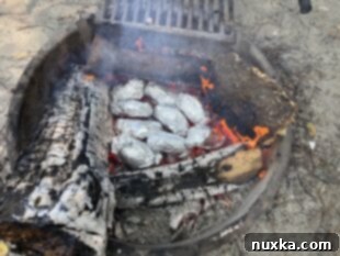image of baked potatoes on embers wrapped in foil