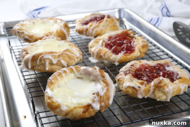 Cream cheese danish recipe with cherry danishes, featuring baked pastries on a cooling rack