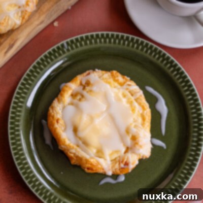 Easy cheese danish with flaky puff pastry on a green plate