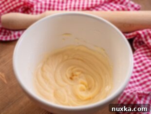 Cream cheese filling ingredients being mixed until smooth