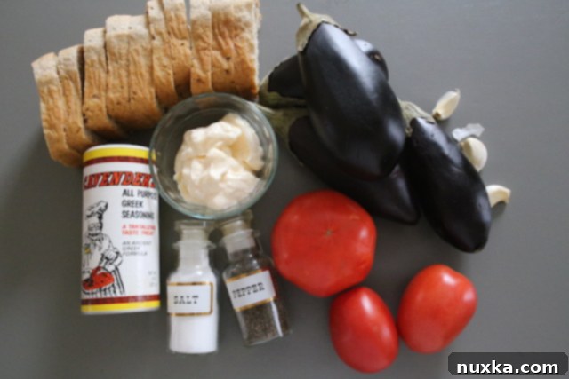 Ingredients for making roasted eggplant sandwiches: eggplant, olive oil, seasoning, tomatoes, mayonnaise, garlic, and bread