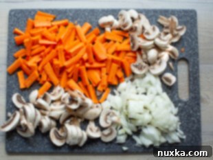Cut and prepped carrots, onions, and mushrooms for mushroom rice.