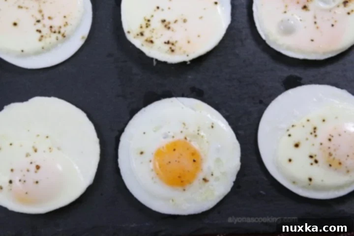 Perfectly baked round egg patties ready for breakfast sandwiches