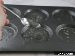 English muffin tin sprayed with cooking spray and water added to each cavity