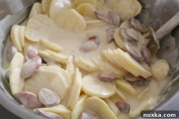 Potato and hot dog mixture in a baking dish before baking