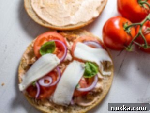 Spreading chipotle mayo and layering ingredients for Frontega Panini