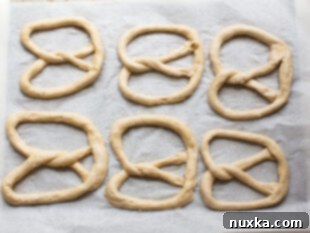 Pretzels on a baking sheet, ready for the oven