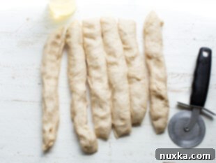 Pretzel dough cut into 6 equal strips