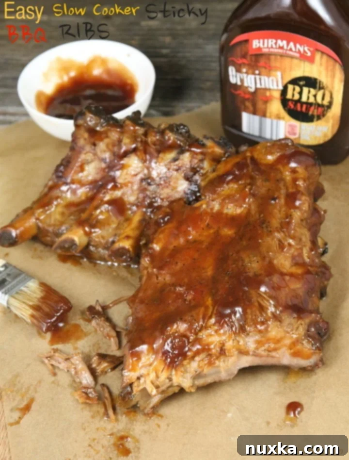 Sticky slow cooker BBQ ribs on a plate, glistening with sauce