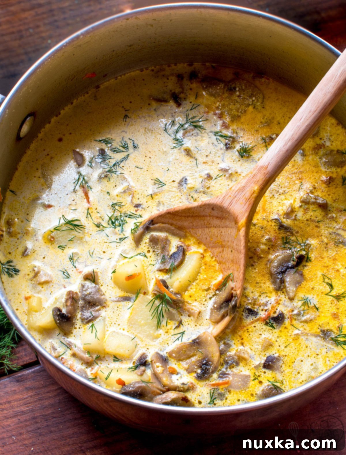 Get ready to eat The BEST Mushroom soup! This recipe is highly-rated, by family and friends, and even kids-approve! All the mushrooms are sauteed with carrots, onion, cream cheese, and sour cream before being added to a pot of simmering potatoes! Garnish with fresh dill and are you in for a seriously delicious soup! #cream #make #recipe the best mushroom soup recipe
