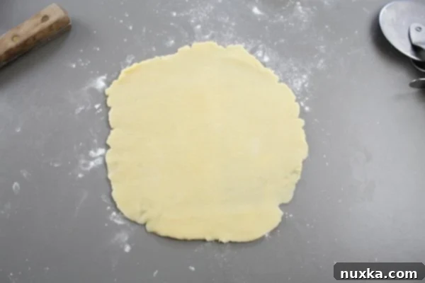 Applying a small amount of Nutella to the widest part of a dough slice