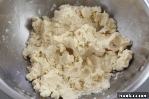 Adding cream cheese and sugar to Rugelach dough mixture