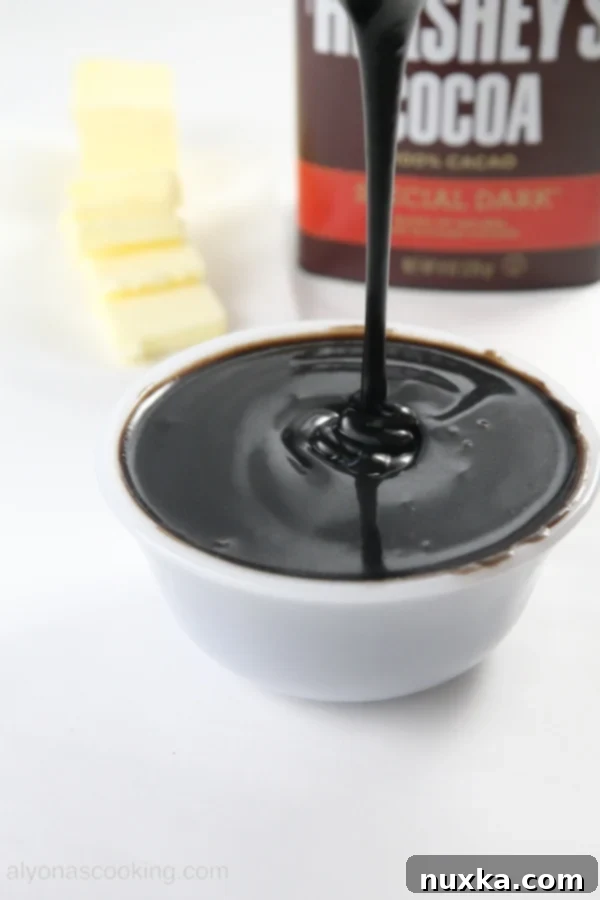 Rich and smooth cocoa ganache, perfect for topping any dessert.