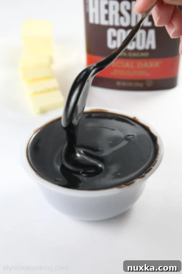 A bowl of freshly made cocoa ganache, showcasing its smooth texture.