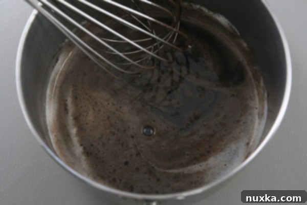 Close-up of the smooth cocoa ganache mixture in a saucepan.