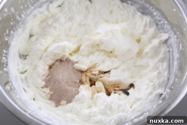 Adding sour cream and coffee to the cream mixture