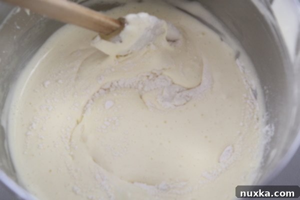 Folding flour into beaten eggs