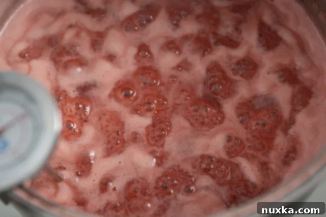 close-up of vigorously boiling strawberry jam