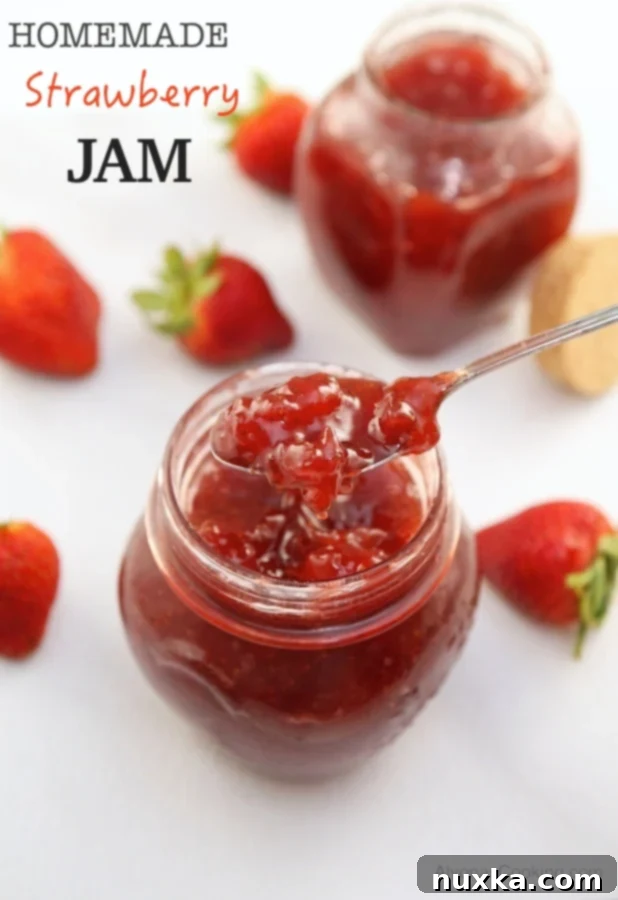 jars of homemade strawberry jam on a rustic wooden surface