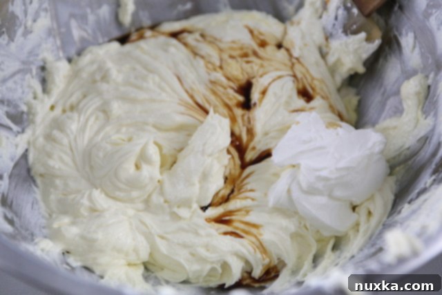 Mixing wet ingredients into the cheesecake batter