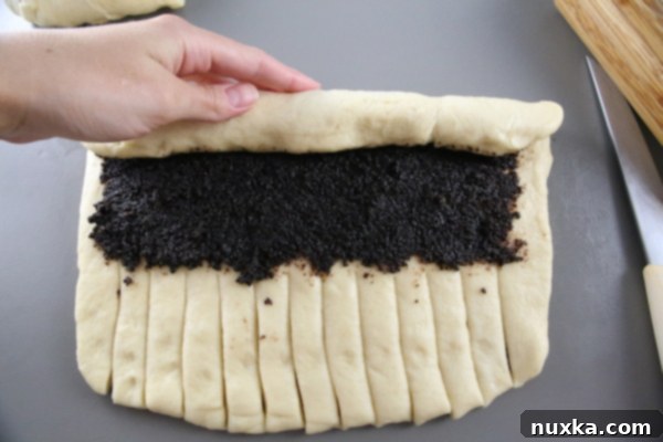 Rolling the poppy seed dough with filling