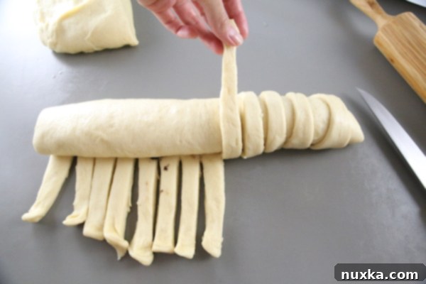 Braiding the poppy seed roll for a decorative finish