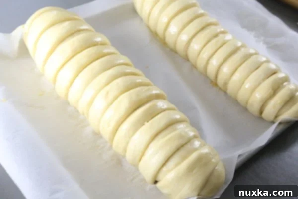 Poppy seed rolls brushed with egg wash before baking