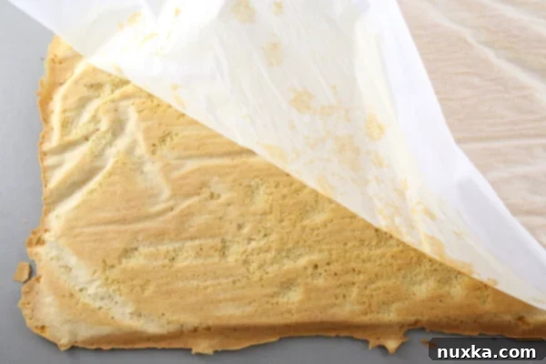 how to peel off parchment paper off of a honey cake Carefully peeling parchment paper off a baked Russian honey cake layer, showing the delicate nature of the thin cake