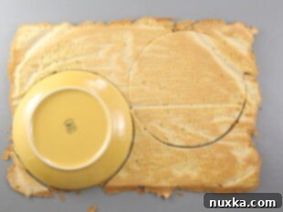 Russian honey cake layers cut out with a plate to make round honey cake layers