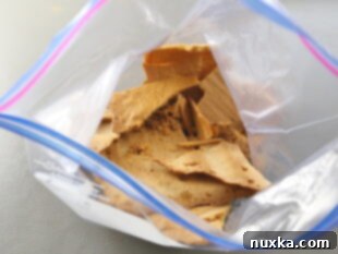 Honey cake crumbs being crushed with a rolling pin after they have been dried in the oven