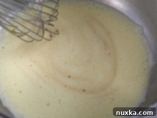 Pecan Pie Batter with eggs, milk, and vanilla combined in a bowl
