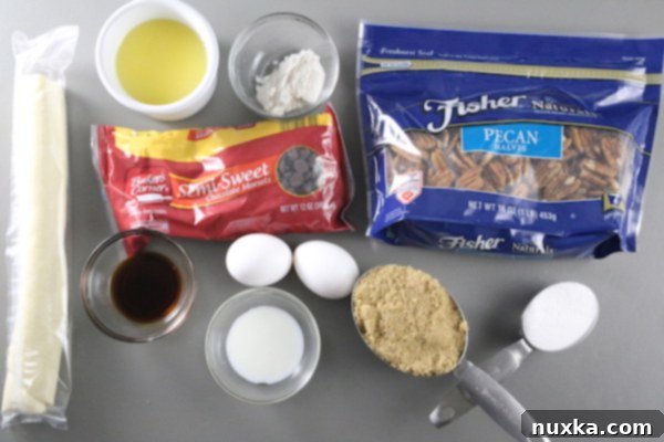 Ingredients for Pecan Pie: pie crust, vanilla, milk, eggs, sugar, flour, butter, and pecans. No Corn syrup! pecan pie ingredients laid out on a surface: pie crust, vanilla, milk, eggs, sugar, flour, butter, and pecans