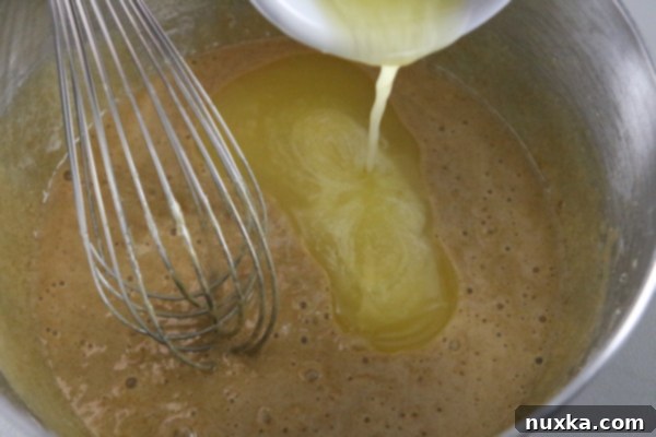 Melted butter melted butter being poured into the pecan pie mixture for richness