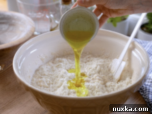 Mixing Italian bread dough together in a bowl by hand