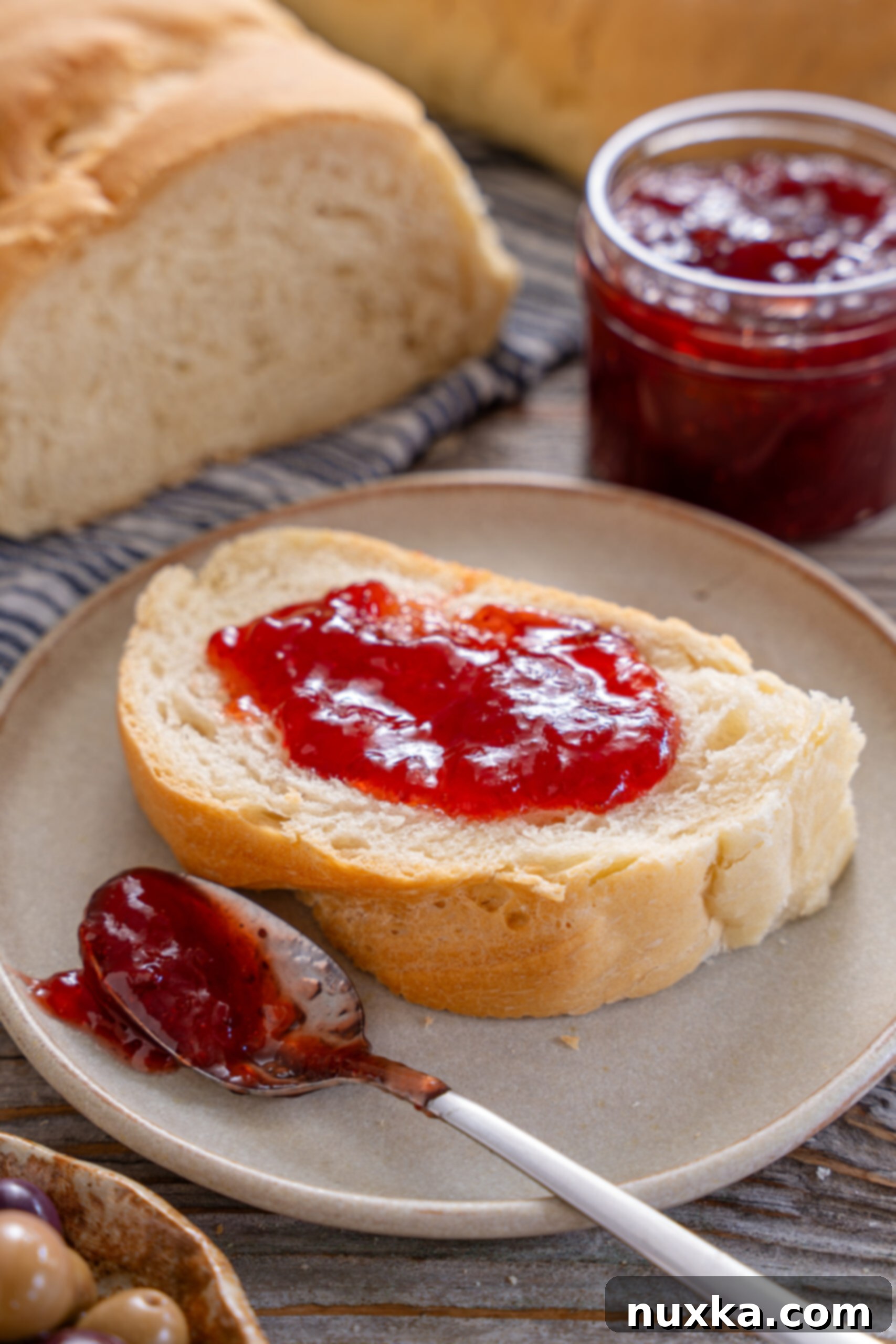 Homemade Italian bread smeared with strawberry jam 