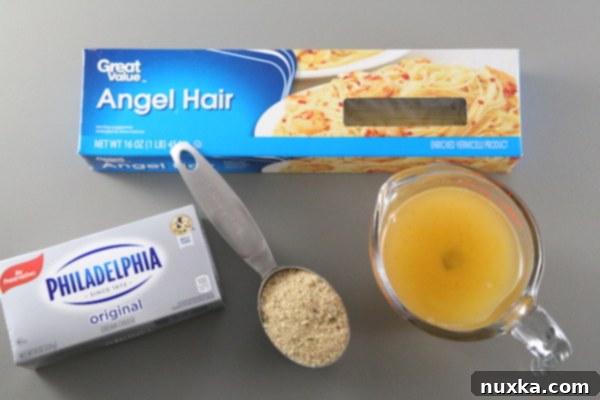 Ingredients laid out for Cream Cheese Pasta, including angel hair, cream cheese, chicken broth, and bread crumbs