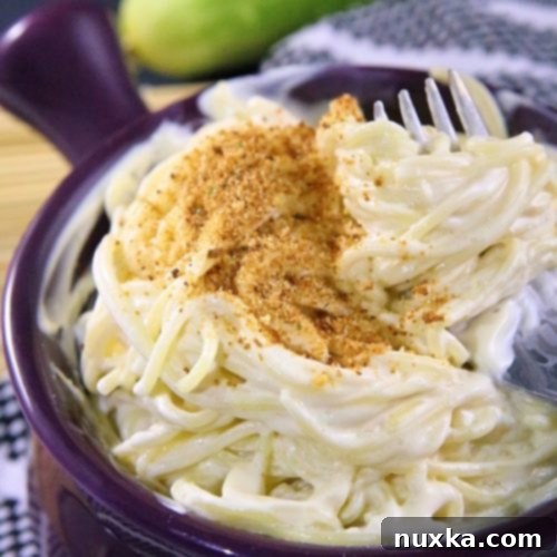 Close-up of creamy cream cheese pasta with a fork
