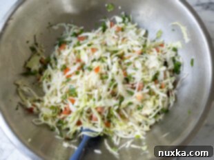 tossed cabbage salad in a mixing bowl