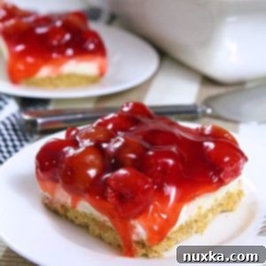 Sweet & Salty Cherry Cheesecake Crunch 14 Full Cherry Pretzel Cheesecake Dessert ready to be served, from an overhead angle.