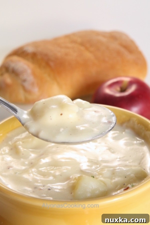 Creamy baked potato soup topped with bacon and green onions