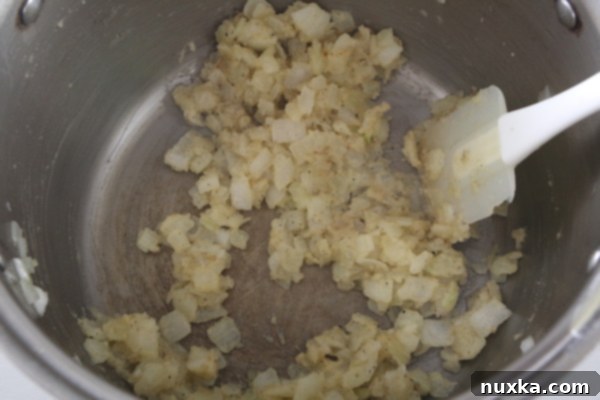 Adding flour and seasonings to create a roux for soup