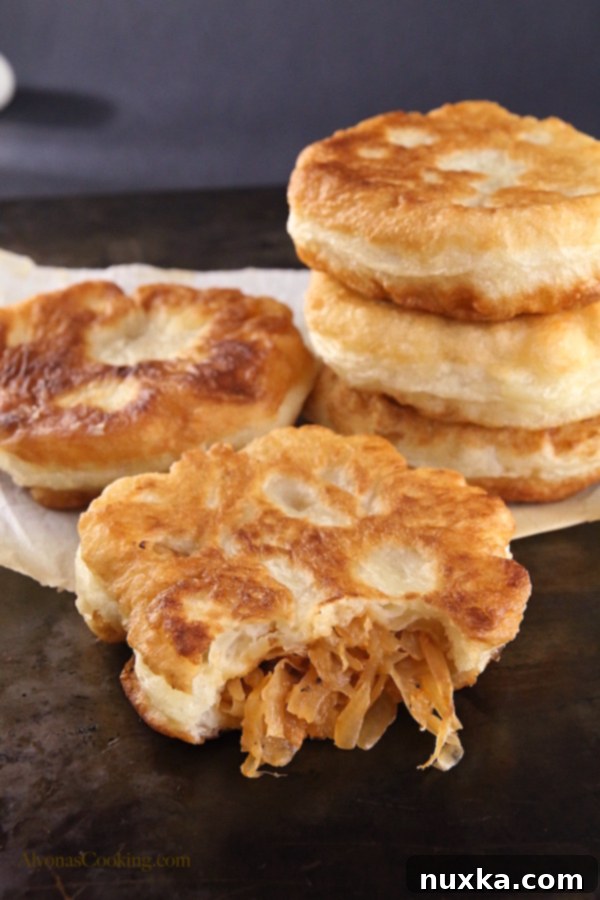 Close-up of a perfectly fried cabbage belyashi, showing its soft texture