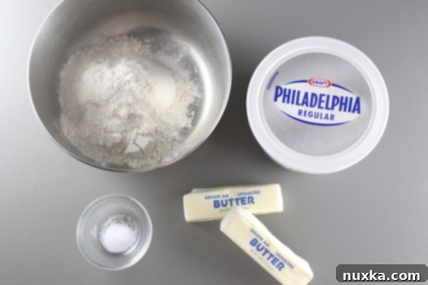 Close-up of ingredients for rugelach dough: softened butter, cream cheese, all-purpose flour, and salt, ready for mixing.