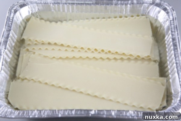 Lasagna noodles softening in hot water