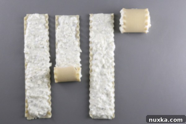 Rolling up lasagna noodles with cheese filling